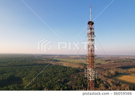 Telecommunications tower on the background of the blue sky in the countryside. 86059566