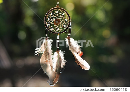 Dreamcatcher object for lucky sign hanging in the nature with beautiful lighting in the evening day 86060458