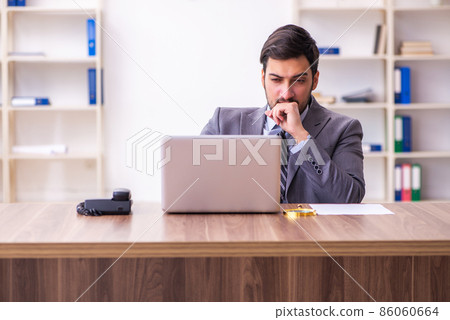 Young handsome businessman employee working in the office Young handsome businessman employee working in the office 86060664