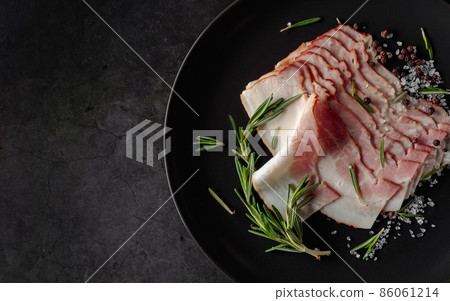 Bacon with rosemary, salt, and pepper. Bacon with rosemary, salt, and pepper. 86061214