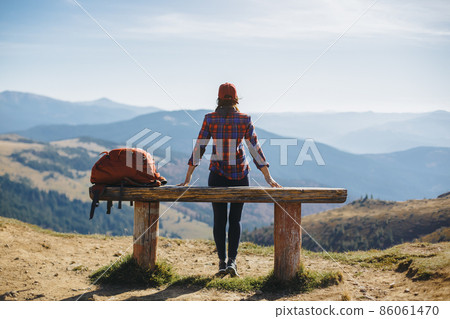 Female Hiker Resting on Top of the Mountaing Female Hiker Resting on Top of the Mountaing 86061470