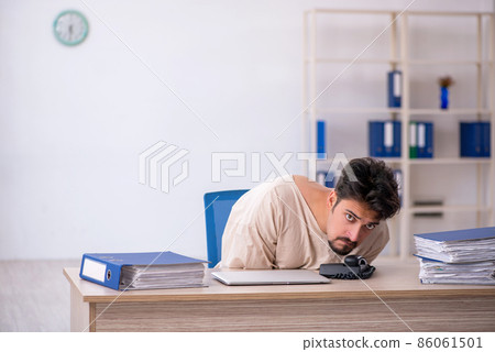 Crazy young man in straitjacket at the office Crazy young man in straitjacket at the office 86061501