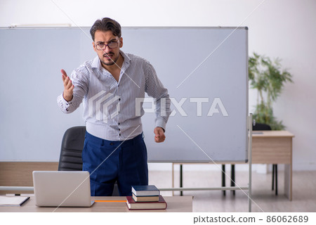 Young male teacher in the classroom Young male teacher in the classroom 86062689