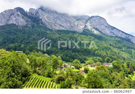 Landscape of Alpine mountains and village, Switzerland, Europe Landscape of Alpine mountains and village, Switzerland, Europe 86062997