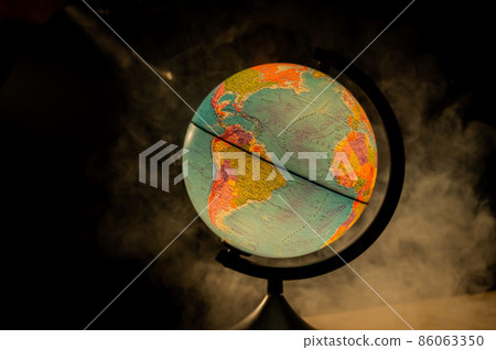 Glowing globe in the dark among the fog. Glowing globe in the dark among the fog. 86063350