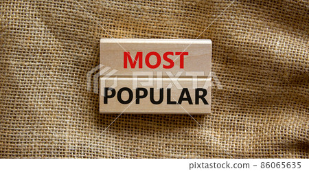 Most popular symbol. Concept words Most popular on wooden blocks on a beautiful canvas background. Copy space. Business and Most popular concept. Most popular symbol. Concept words Most popular on wooden blocks on a beautiful canvas background. Copy space. Business and Most popular concept. 86065635