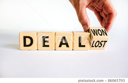 Deal lost or won symbol. Businessman turns a wooden cube and changes words deal lost to deal won. Beautiful white table, white background, copy space. Business and deal lost or won concept. Deal lost or won symbol. Businessman turns a wooden cube and changes words deal lost to deal won. Beautiful white table, white background, copy space. Business and deal lost or won concept. 86065703