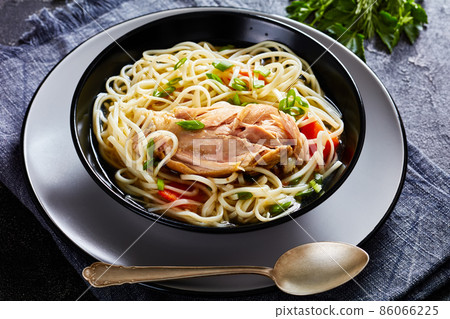 chicken noodle soup with carrots and scallion 86066225