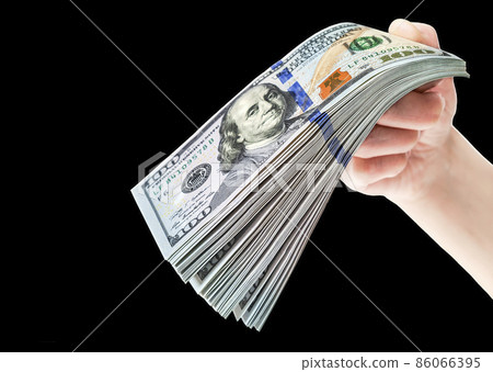 Hand with stack of one hundred american dollar bills on black Hand with stack of one hundred american dollar bills on black 86066395