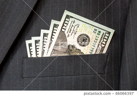 American dollar banknotes in businessman suit pocket American dollar banknotes in businessman suit pocket 86066397