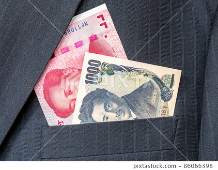 Banknotes of Chinese and Japanese currency in businessman suit pocke Banknotes of Chinese and Japanese currency in businessman suit pocke 86066398