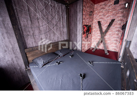 BDSM Leather handcuffs for role-playing games on a gray sheet. Bondage for carnal pleasures. Domination and submission. BDSM Leather handcuffs for role-playing games on a gray sheet. Bondage for carnal pleasures. Domination and submission. 86067383