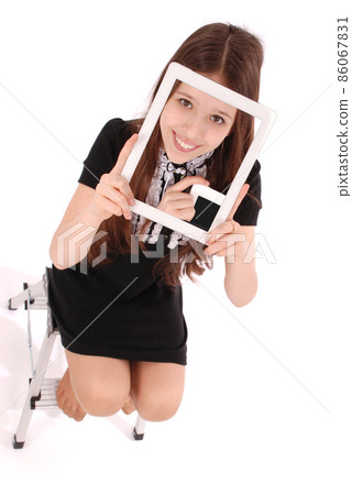 Student teenage girl sitting on the ladder with digital tablet making selfie Student teenage girl sitting on the ladder with digital tablet making selfie 86067831