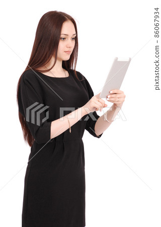 Happy student teenage girl keeps tablet pc standing sideways Happy student teenage girl keeps tablet pc standing sideways 86067934