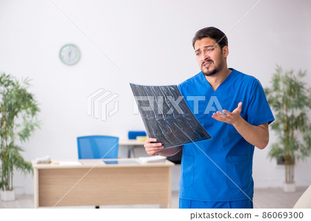 Young male doctor radiologist sitting in the clinic 86069300