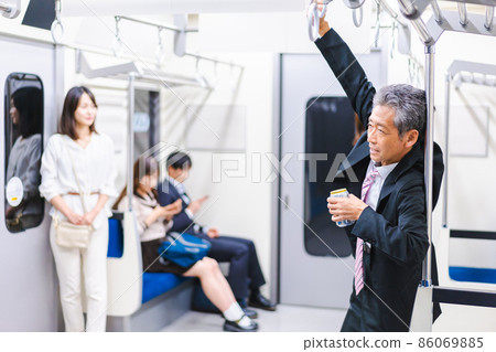 Middle-aged man drinking on the train Middle-aged man drinking on the train 86069885