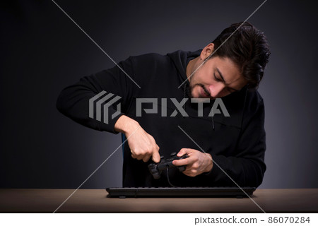 Young male gamer on grey background Young male gamer on grey background 86070284