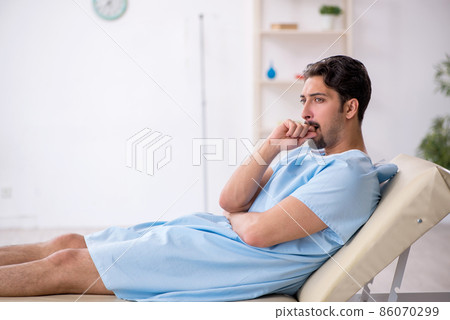 Young male patient waiting for doctor at the hospital 86070299