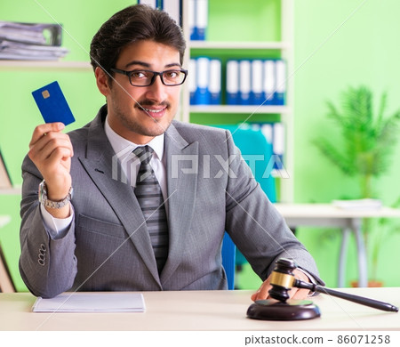 Young handsome lawyer working in the office 86071258