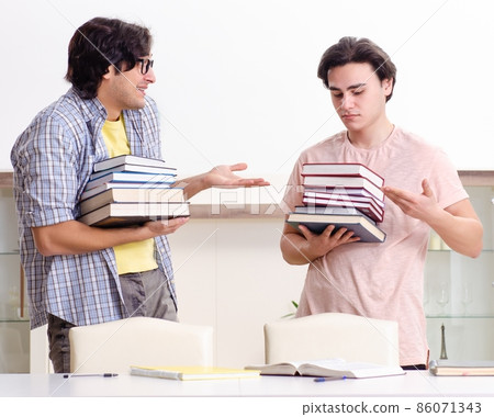 Two male students preparing for exams at home Two male students preparing for exams at home 86071343