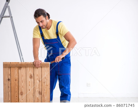 Young male contractor working indoors Young male contractor working indoors 86071745