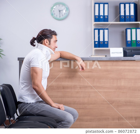 Young man at hospital reception desk Young man at hospital reception desk 86072872