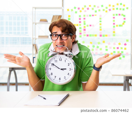 The student struggling at the exam in classroom 86074462