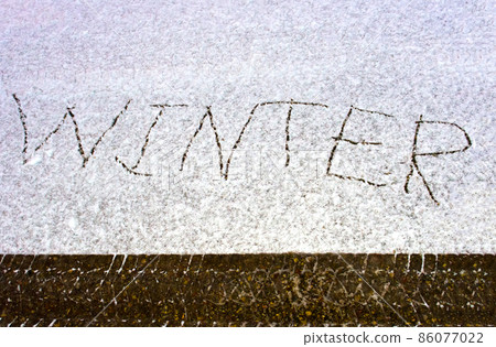 Car track in fresh snow and the inscription on the snow WINTER 86077022