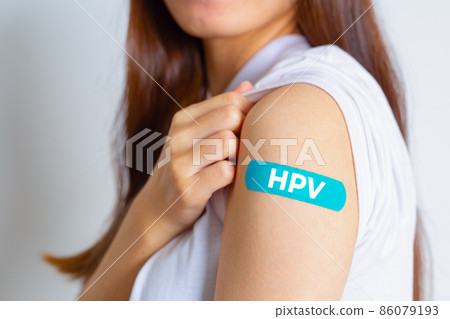 HPV (Human Papillomavirus) Teenager woman showing off an blue bandage after receiving the HPV vaccine.viruses Some strains infect genitals and can cause cervical cancer. Woman health concept. HPV (Human Papillomavirus) Teenager woman showing off an blue bandage after receiving the HPV vaccine.viruses Some strains infect genitals and can cause cervical cancer. Woman health concept. 86079193