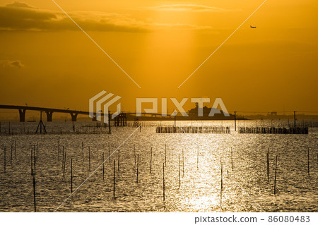 An artificial island floating in the sea at sunset 86080483