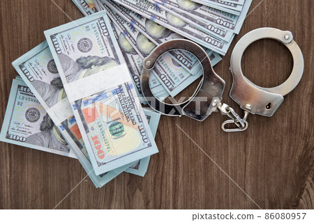 Concept for corruption, fraud and money laundry. Handcuff Concept for corruption, fraud and money laundry. Handcuff 86080957