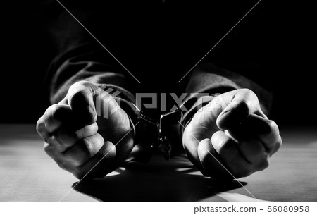 Arrested criminal hands locked in handcuffs. Arrested criminal hands locked in handcuffs. 86080958