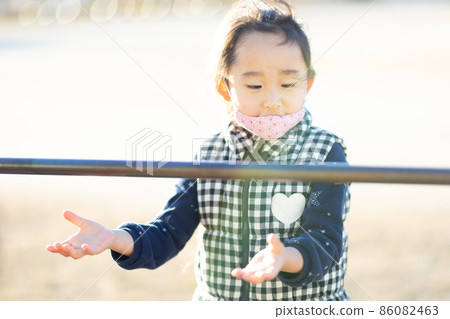 Girl practicing horizontal bar Girl practicing horizontal bar 86082463