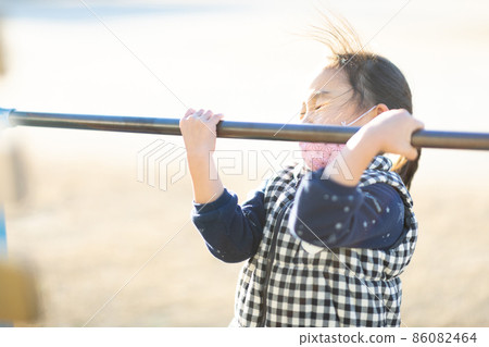 Girl practicing horizontal bar Girl practicing horizontal bar 86082464