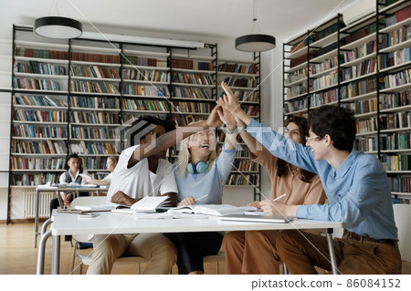 Interracial group of college girl and guys giving high five Interracial group of college girl and guys giving high five 86084152