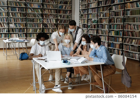 Diverse group of school teen students doing research study together Diverse group of school teen students doing research study together 86084154