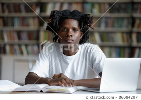 Serious African American college student with trendy dreads Serious African American college student with trendy dreads 86084297