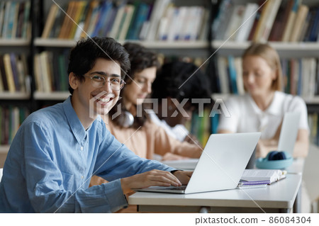 Happy high school student in glasses working on project Happy high school student in glasses working on project 86084304