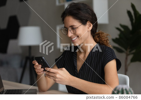 Distracted happy millennial businesswoman using smartphone application. 86084766