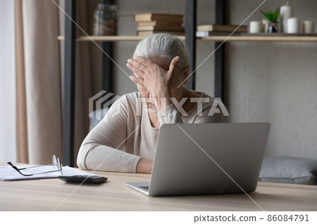Unhappy old senior retired woman having financial problems. Unhappy old senior retired woman having financial problems. 86084791