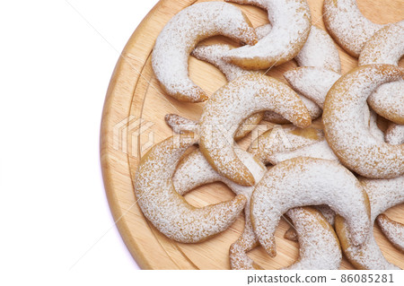 Traditional German or Austrian Vanillekipferl vanilla kipferl cookies on wooden serving board Traditional German or Austrian Vanillekipferl vanilla kipferl cookies on wooden serving board 86085281
