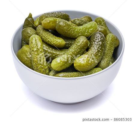 Plate of Tasty canned Whole green cornichons isolated on a white background 86085303