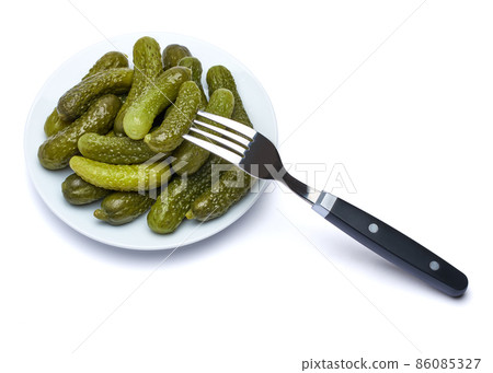 Plate of Tasty canned Whole green cornichons isolated on a white background 86085327