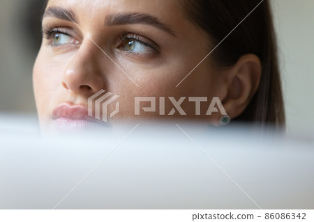 Thoughtful young business woman using laptop computer 86086342