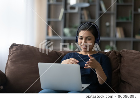 Happy young Indian woman holding video call conversation. Happy young Indian woman holding video call conversation. 86086895