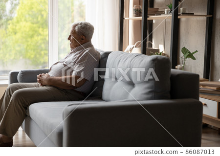 Relaxed happy old 80s man sitting on couch at home. Relaxed happy old 80s man sitting on couch at home. 86087013