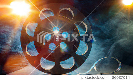 Metal reel of film on a dark background Metal reel of film on a dark background 86087014