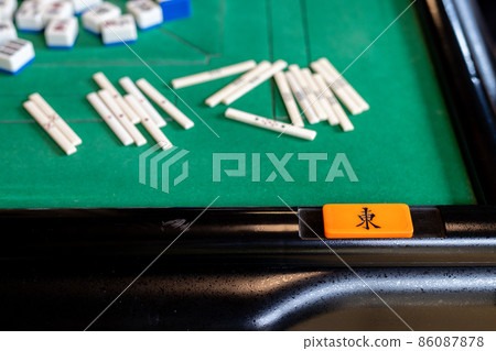 A tile and a stick on the electric mahjong table A tile and a stick on the electric mahjong table 86087878