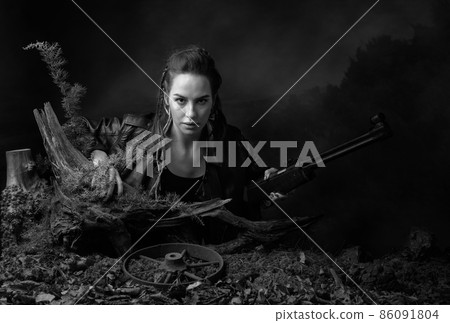 Portrait of a young woman with a rifle. 86091804