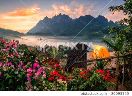 Sunrise on Doi Luang Chiang Dao mountain with foggy, flower blooming and tent camping on balcony in traditional village 86093569